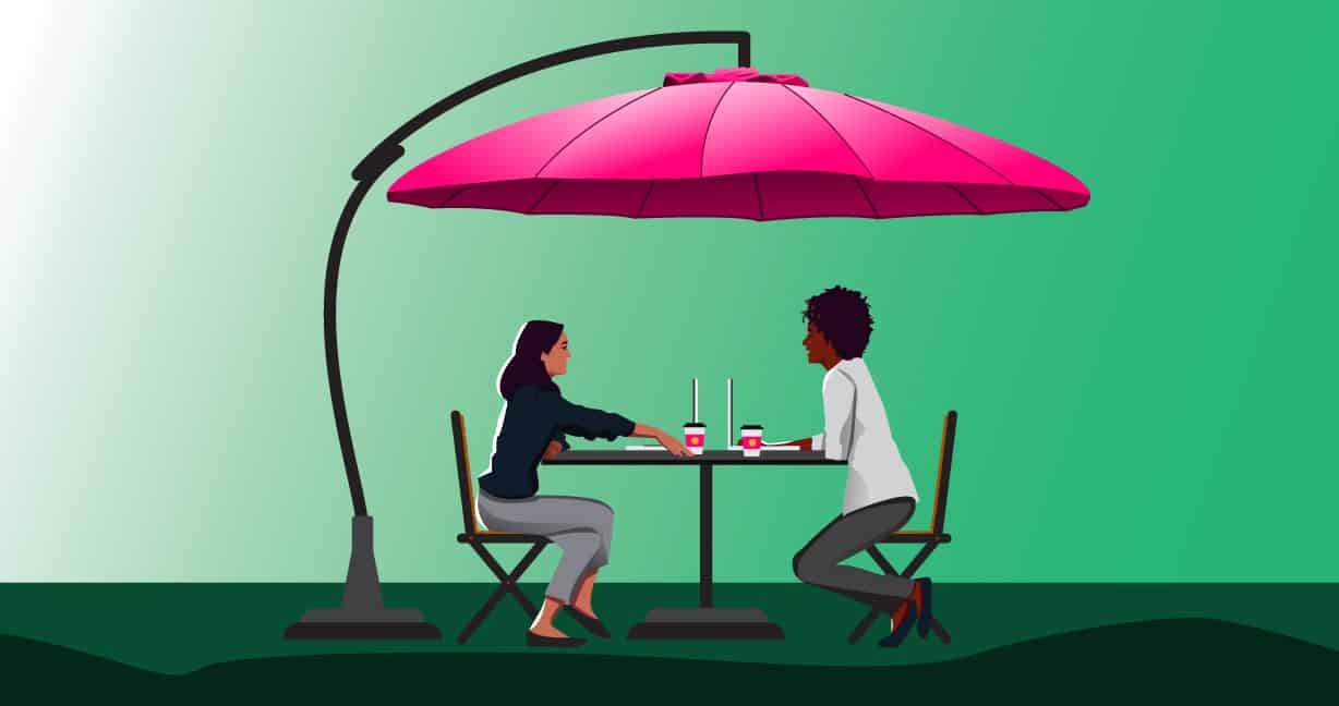 Work from home co-workers talking under a pink umbrella outside